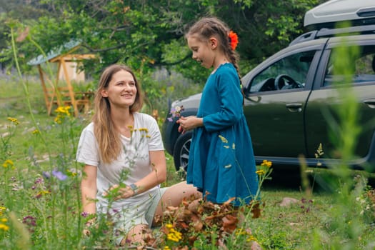 A mother and her daughter share joyful, playful moments while enjoying the stunning beauty of nature all around them