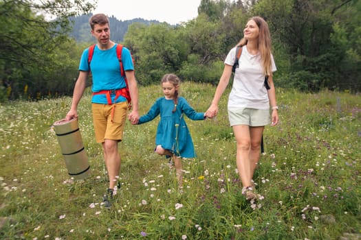 A cheerful and happy family joyfully enjoys a delightful hike together in a lush, vibrant, flowerfilled landscape