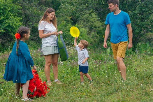 A joyful family happily spending quality time together outdoors in nature while the children are playing