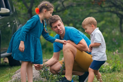 A delightful and joyful family moment of exploration and discovery alongside their children in a scenic natural setting