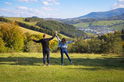 very beautiful panorama of the Carpathians in the autumn-a beautiful couple stands with their backs.