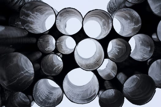 A detailed view of industrial metal pipes arranged in a circular pattern, creating a tunnel effect