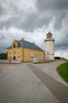 the old Historic Lighthouse and Yellow Building Under Cloudy Sky in hansholm in the thy national park in denmark