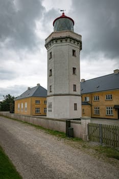 the old Historic Lighthouse and Yellow Building Under Cloudy Sky in hansholm in the thy national park in denmark