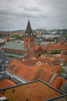 Denmark, Jutland, Aalborg, elevated city view from a rooftop with the church and houses with red rooftops