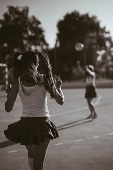 A vibrant and dynamic capture of young athletes playing energetically and passionately on the sports court