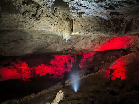 Prometheus Cave, Georgia, tools inside Kumistavi cave,nature park unique reserve, tourism, red light earth stalactites stalagmites dark closed place space tourist center object travel near Tskaltubo