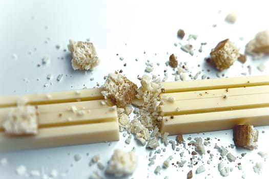 Realistic depiction of scattered small pieces of cheese on a clean white background, Generated by AI