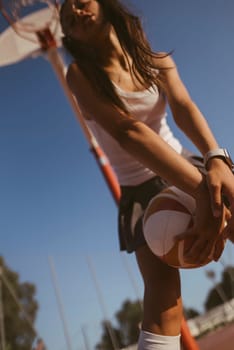 An energetic and dynamic scene capturing a determined young female basketball player as she prepares to take a shot