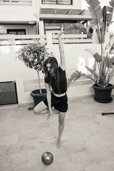A dancer striking a powerful and dynamic pose outdoors, beautifully capturing both energy and elegance