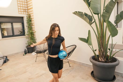 A woman passionately enjoys bowling indoors, showcasing her unique style and athleticism in a chic environment