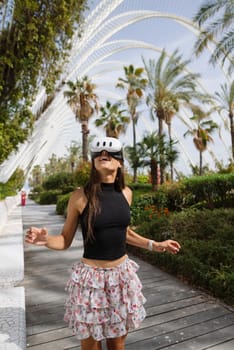 A cheerful young woman in a stylish and trendy outfit glides gracefully while skating among lush palm trees