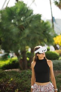 A woman, fully immersed and wearing a VR headset, is exploring a wonderfully vibrant and colorful outdoor setting