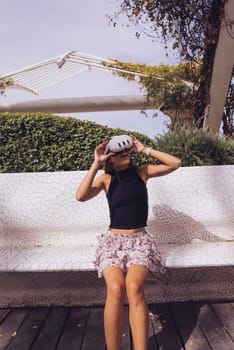 A fashionable young woman is relishing a beautiful sunny day outdoors while showcasing her unique and stylish outfit