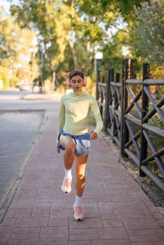A young woman jogs along a tree-lined path, showcasing an active lifestyle in vibrant athleisure wear.