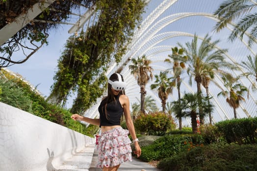 A fashionable and stylish woman enjoys a leisurely stroll through a vibrant and colorful tropical landscape