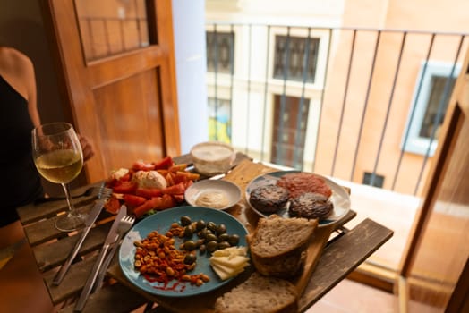 A wonderfully delightful table setting showcasing a variety of exquisite dishes accompanied by a glass of wine