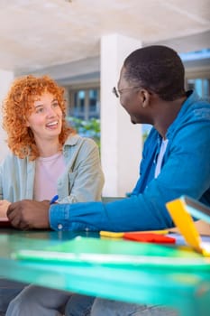 Multiracial college assignments and learning classes studying sitting around the university campus.Vertical