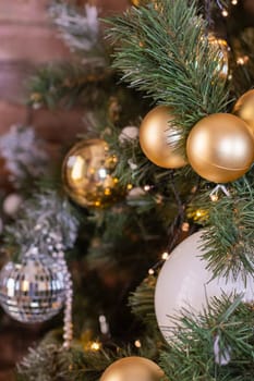 Christmas tree branches with decorations, balls, garlands, bokeh. Postcard with space for text.