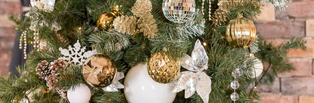 Christmas tree branches with decorations, balls, garlands, bokeh. Postcard with space for text.