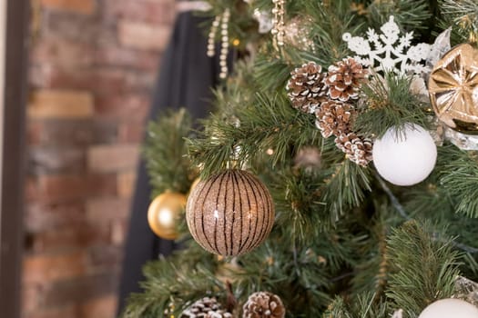 Christmas tree branches with decorations, balls, garlands, bokeh. Postcard with space for text.
