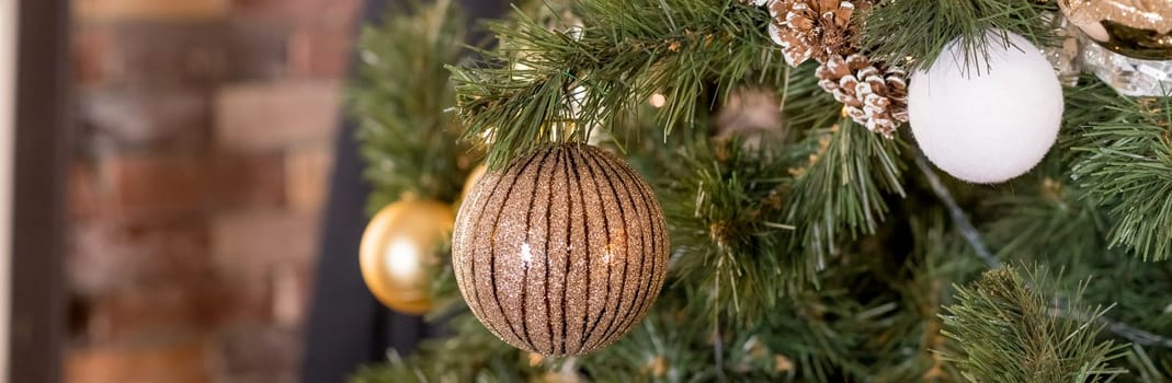 Christmas tree branches with decorations, balls, garlands, bokeh. Postcard with space for text.