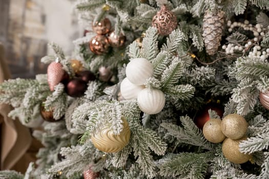 Christmas tree branches with decorations, balls, garlands, bokeh. Postcard with space for text.