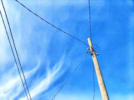 Old pole with wires against the sky. Electric transmission line, Eco-friendly energy