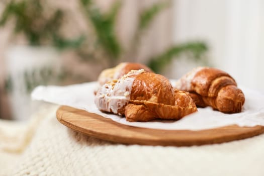 Delicious fresh french croissants on wooden tray for breakfast in bed in the morning, tasty breakfast