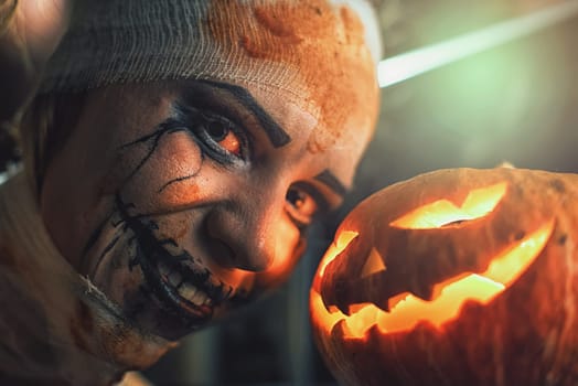 Horrible woman with scary mouth and eyes and pumpkin. Halloween holiday concept