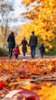 Family is walking away on a path in a forest covered with colorful autumn leaves