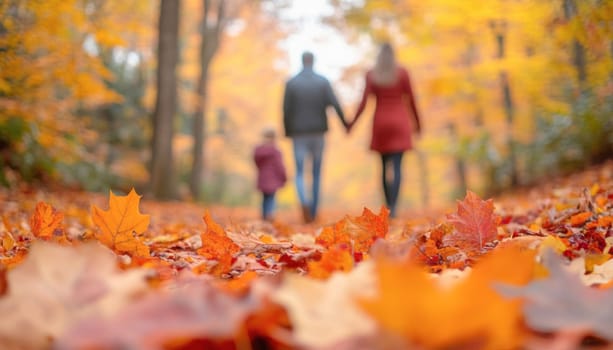 Family is enjoying a hike together on a trail covered in colorful fallen leaves