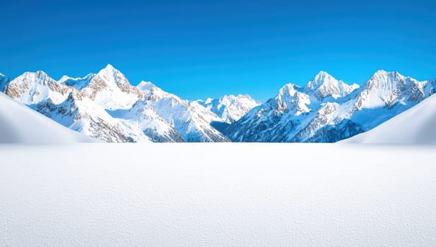 Majestic snow capped mountain peaks against a clear blue sky