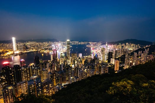 HONG KONG, CHINA - SEPTEMBER 29, 2024: Iconic view around sunset from Lugard Rd Lookout which overlooks Hong Kong Island and Kowloon in Hong Kong, China