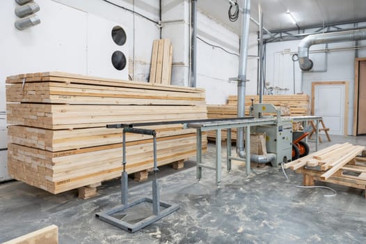 Stacked wooden planks close-up at lumber warehouse. Wood industry concept