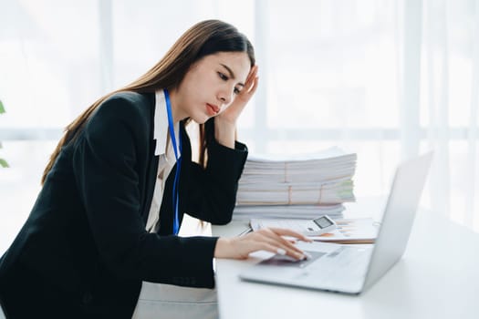 Portrait of business owner, woman using computer and financial statements Anxious expression on expanding the market to increase the ability to invest in business.