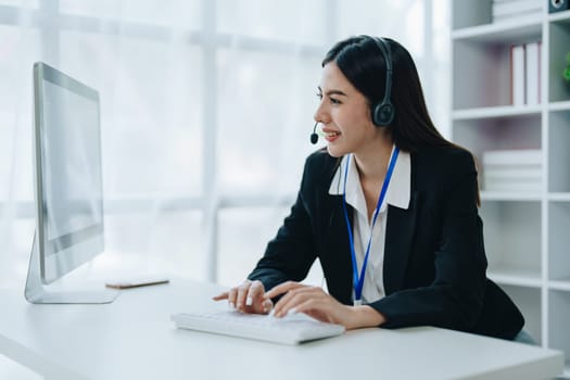 young business woman wear wireless headset video conference calling on laptop computer talk by webcam discussing in online meeting about budget and profit of company.