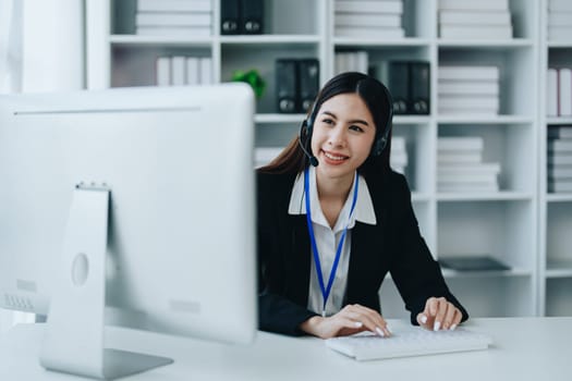 young business woman wear wireless headset video conference calling on laptop computer talk by webcam discussing in online meeting about budget and profit of company.