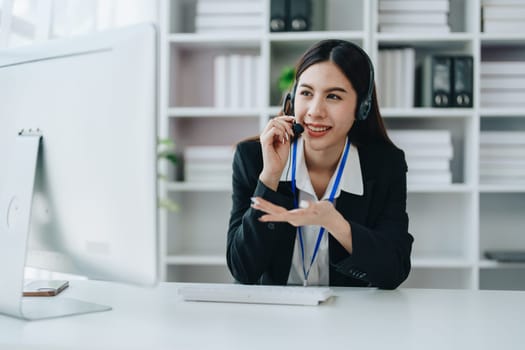 young business woman wear wireless headset video conference calling on laptop computer talk by webcam discussing in online meeting about budget and profit of company.