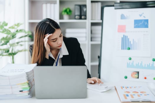 Portrait of business owner, woman using computer and financial statements Anxious expression on expanding the market to increase the ability to invest in business.