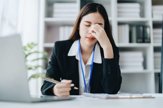 Portrait of business owner, woman using computer and financial statements Anxious expression on expanding the market to increase the ability to invest in business.