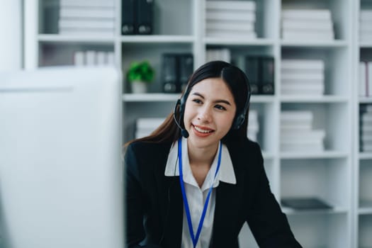 young business woman wear wireless headset video conference calling on laptop computer talk by webcam discussing in online meeting about budget and profit of company.