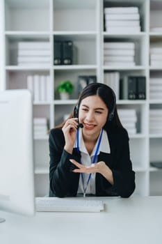 young business woman wear wireless headset video conference calling on laptop computer talk by webcam discussing in online meeting about budget and profit of company.