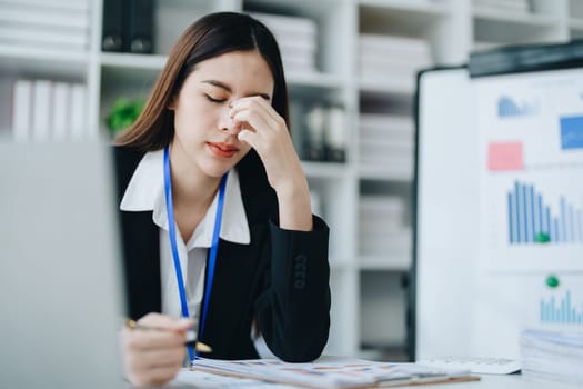 Portrait of business owner, woman using computer and financial statements Anxious expression on expanding the market to increase the ability to invest in business.