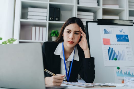 Portrait of business owner, woman using computer and financial statements Anxious expression on expanding the market to increase the ability to invest in business.