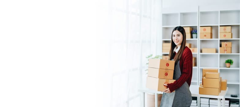 Asian female business owner handles delivery of orders to customers.