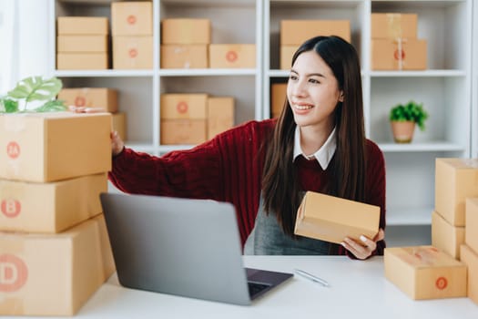 Asian female business owner handles delivery of orders to customers.