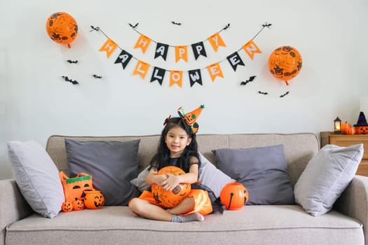 Cute little child girl with balloon. Happy family preparing for Halloween.