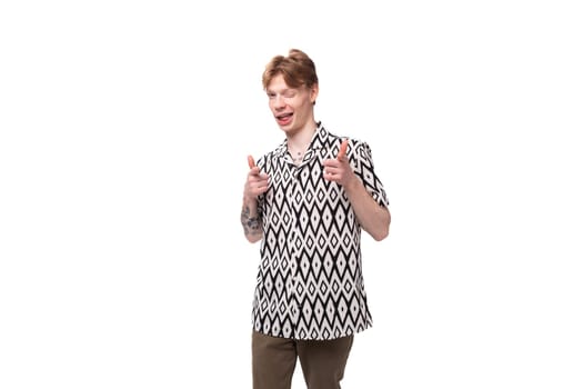 young red-haired man in a summer shirt with a rhombus print on a background with copy space.