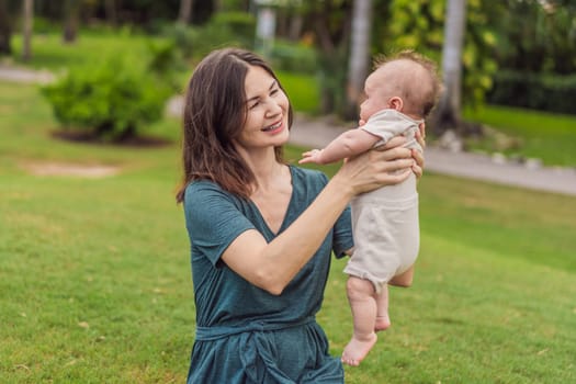 A happy 40-year-old mother cradles her newborn in a sun-drenched park. Love, family and generations in harmony.